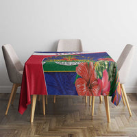 Blue and red Haiti map tablecloth with hibiscus flower print centered on tabletop