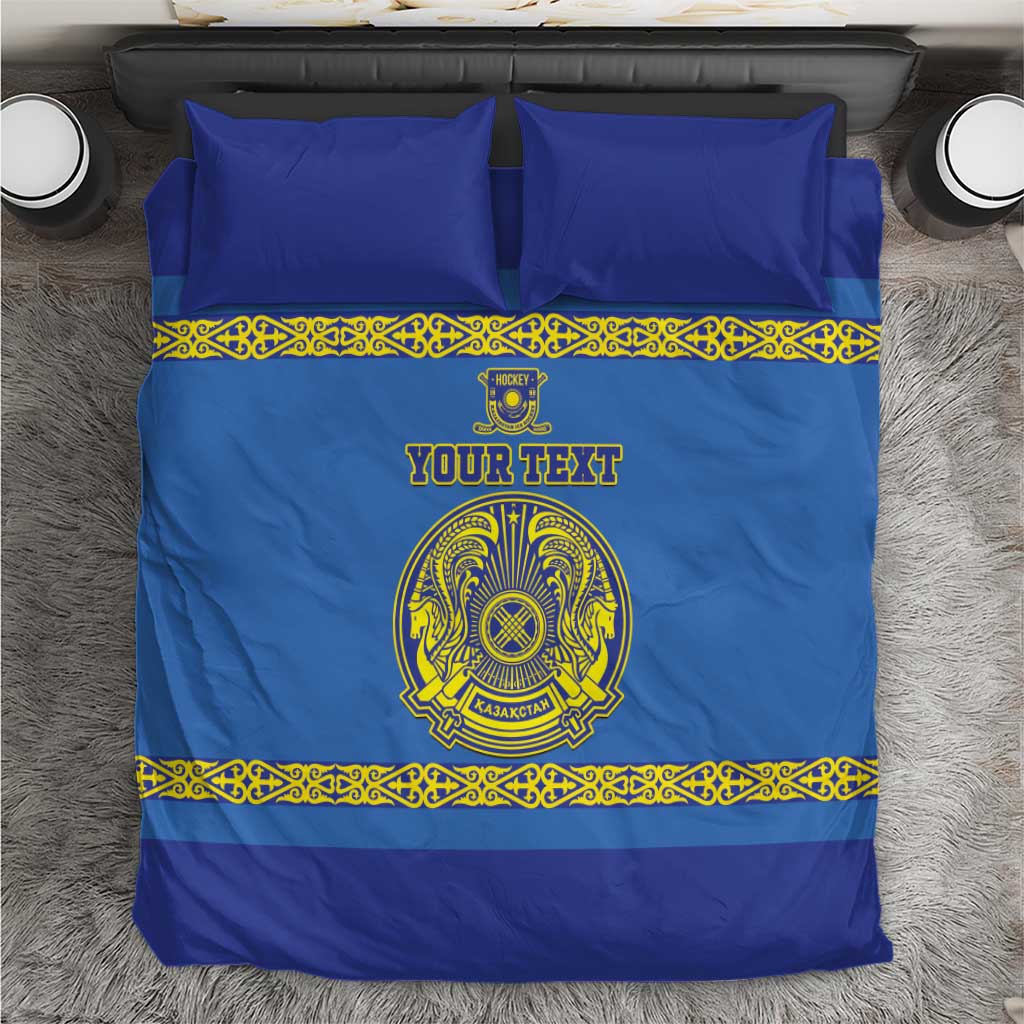 Blue bedding set with yellow patterned border and central crest, includes two pillows