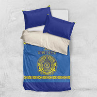 Blue duvet bedding set with two blue pillows and yellow crest on the front
