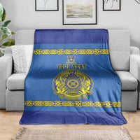 Blue custom hockey blanket on a sofa with gold border, crest emblem and personalized text