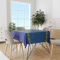 Blue hockey tablecloth with yellow ornamental border draped over dining table