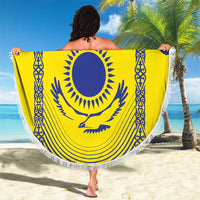 Round beach blanket held up, yellow-and-blue Kazakh flag design with tassel fringe border.