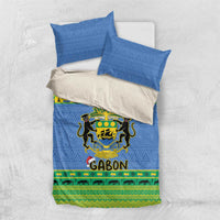 Blue bedding set with two pillows; Gabon crest design with green stripe band and yellow trim