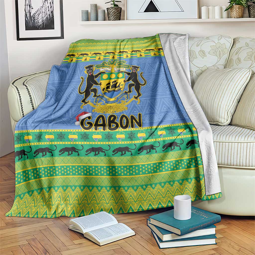 Blue Christmas blanket with coat of arms crest, green/yellow stripes, and animal border