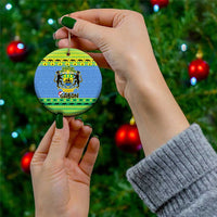 Blue round Gabon ceramic ornament held in hand with hanging gold string