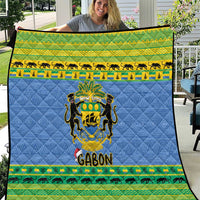 Blue quilt blanket with Gabon coat of arms, animals border, and green patterned trim.