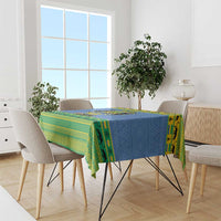 Blue and green holiday tablecloth with Gabon crest design on a dining table