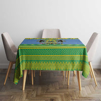 Blue and green Gabon crest holiday tablecloth on a square table