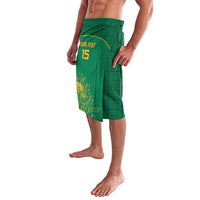 Green cricket lavalava shorts with elastic waistband, yellow "YOUR TEXT" and number 15