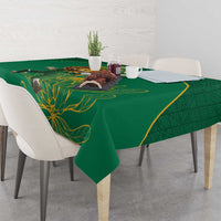 Green cricket tablecloth with gold floral artwork and decorative border