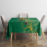Green tablecloth featuring gold floral line art on tabletop