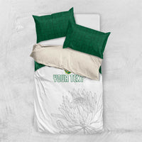 White duvet cover with floral line art and custom text; green pillowcases