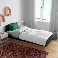 Bedding set on bed: white duvet with floral sketch and green accent panel and pillows