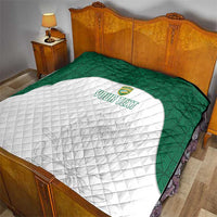 Cricket quilt on a bed: green border with white quilted shield and “YOUR TEXT”