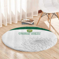 Round white cricket-themed rug with green border, crest logo, gray leaf design, 'YOUR TEXT', angled.