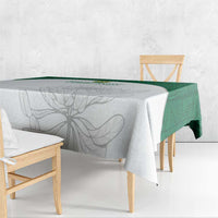 Square tablecloth draped over table with gray floral motif and green border
