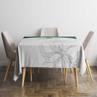 Light tablecloth with gray botanical print and green top edge on dining set
