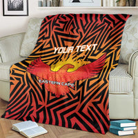 Cricket blanket on couch arm, large Eastern Cape eagle artwork with red wings over black pattern