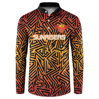 Orange and black geometric button-up cricket sweatshirt with stand collar and long sleeves.