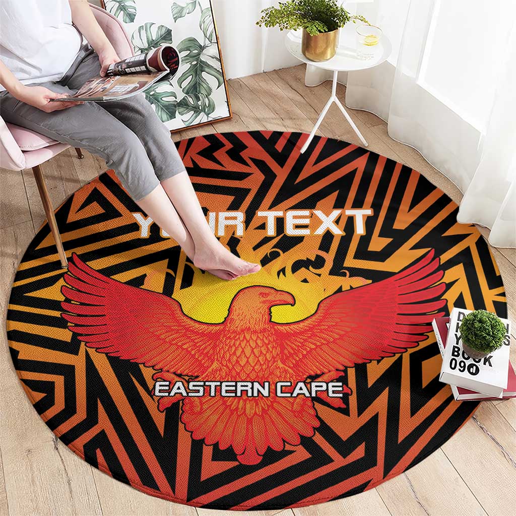 Round orange sports carpet with black geometric border, red wings, and yellow bird center