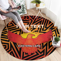 Round orange sports carpet with black geometric border, red wings, and yellow bird center