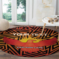 Round orange cricket carpet featuring black geometric pattern, red wings, and yellow bird