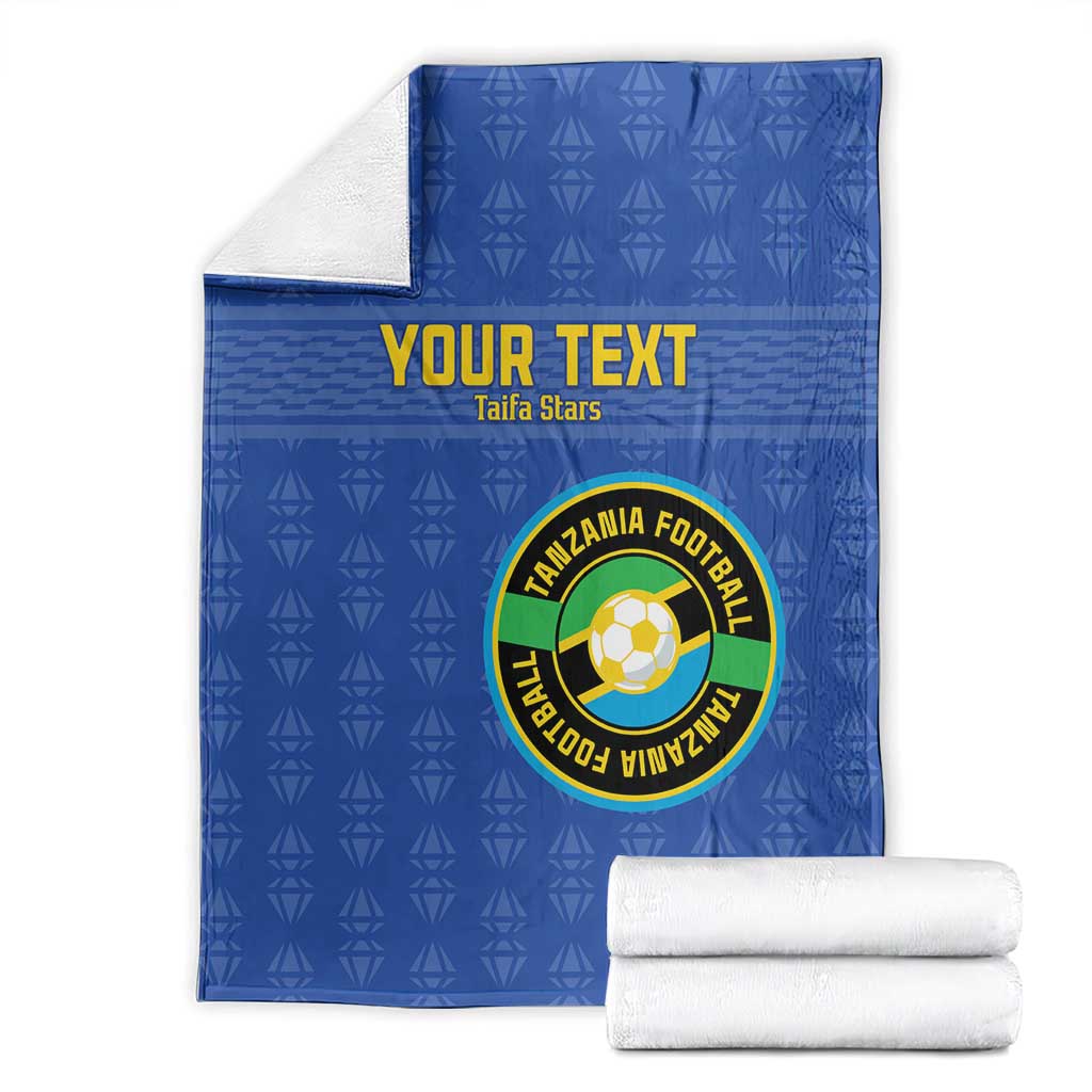 Blue custom football blanket folded with Tanzania logo, 'YOUR TEXT' and pattern