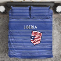 Blue bedding set with striped pattern and Liberia emblem, matching pillow shams