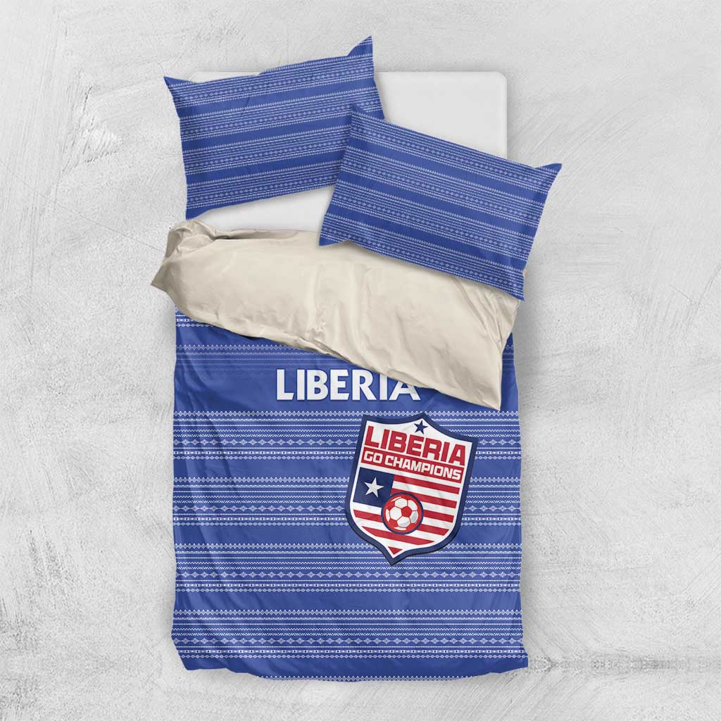 Blue striped duvet and pillow shams with Liberia emblem, flat-lay set