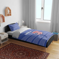 Blue striped bedding set with Liberia logo on duvet, bed with two pillow shams