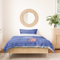 Blue striped bedding set with Liberia crest on duvet, styled on a single bed
