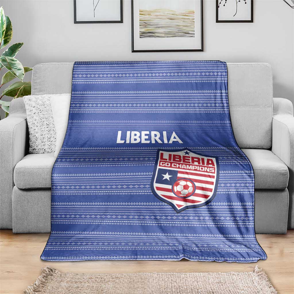 Blue striped football blanket with LIBERIA text and team crest, on gray couch