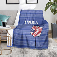 Blue football blanket with Liberia crest on striped fabric, draped over chair