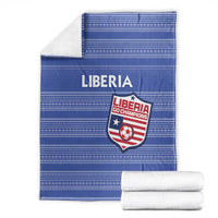 Blue Liberia football blanket with crest and stripes, with two folded white towels