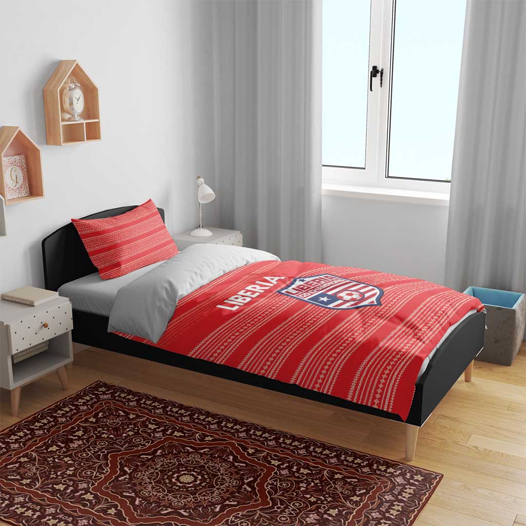 Red Liberia football bedding set on bed with striped duvet and pillow featuring logo crest