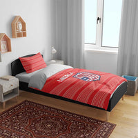 Red Liberia football bedding set on bed with striped duvet and pillow featuring logo crest