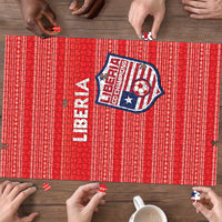 Close-up of red Liberia jigsaw puzzle showing the crest and interlocking puzzle edges