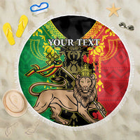 Round beach blanket with Lion of Judah graphic, green red yellow pattern, white fringe