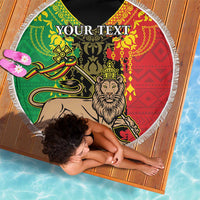 Round beach blanket with Lion of Judah graphic, multicolor green red yellow pattern, white fringe