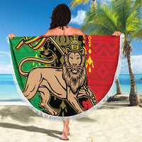 Round beach blanket held up, Lion of Judah graphic in green red yellow, white fringe