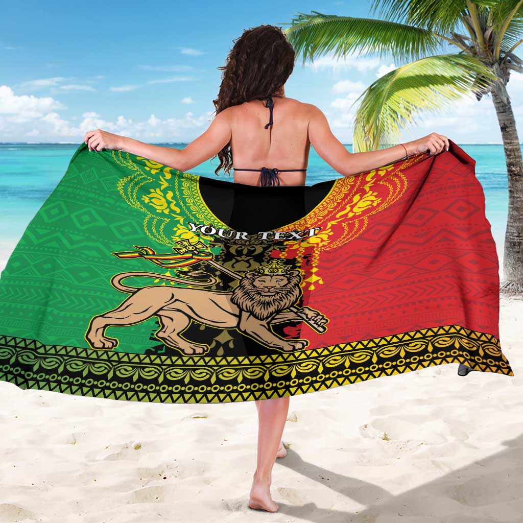 Red and green Lion of Judah sarong, 'YOUR TEXT' across center, gold patterned hem