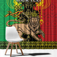Close-up window curtain featuring Lion of Judah illustration on green and red patterned fabric.