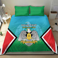 Personalised bedding set on bed: teal duvet with green pillowcases, centered coat-of-arms emblem