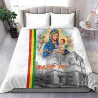White bedding set: duvet cover with Mary and baby artwork and Ethiopian flag stripe