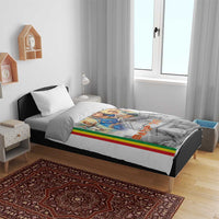 White duvet cover on bed with Mary and baby print, Ethiopian flag stripe along one side