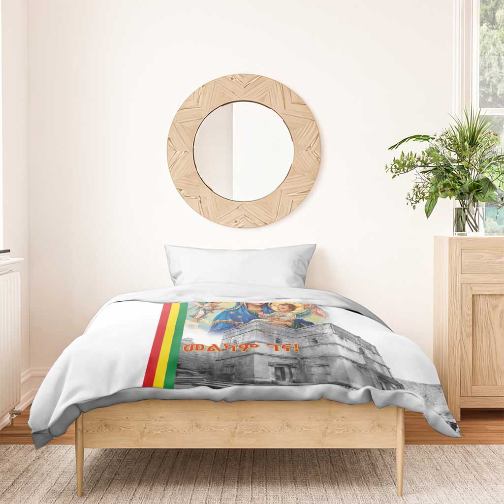 White duvet cover over a bed with Mary and baby church artwork and Ethiopian flag stripe