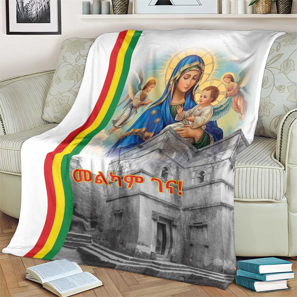Christmas blanket on living room couch, Saint Mary and baby with rainbow stripe, church print