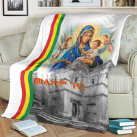 Christmas blanket on living room couch, Saint Mary and baby with rainbow stripe, church print