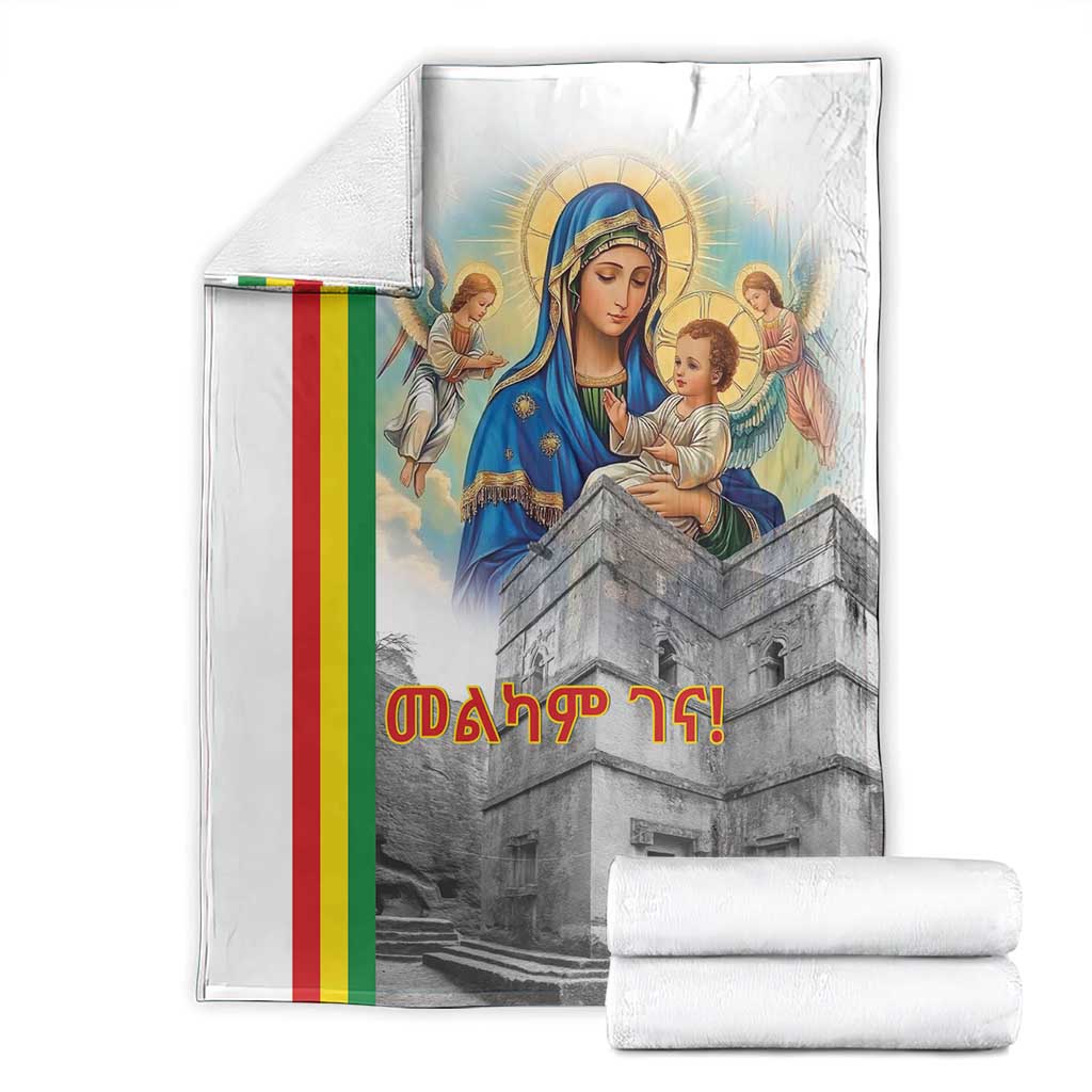 Christmas blanket laid flat with Saint Mary and church tower, rainbow stripe, rolled towels