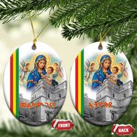 Two round white ceramic Christmas ornaments with Saint Mary and church artwork, gold loops